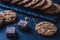 Handmade chocolate chip cookies and pieces of cocoa on a chalkboard table. Front view