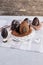 Handmade chocolate Easter eggs on a table decorated with satin ribbons, on wooden background