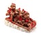 Handmade Christmas bears in sleigh in red and gold jackets and hats on snow isolated
