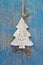 Handmade christmas decoration - tree carved on a blue wooden christmas background