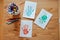 Handmade christmas handprints post cards and pencils on wooden table