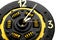 Handmade clock on a white background. A clock from a car clutch disc. Black watch with gold elements