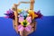 Handmade colored paper flowers origami bouquet paper craft art in a basket with grass in the studio on colored