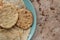 Handmade corn tortillas on green plate on a stone background top view