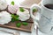 Handmade cream and strawberry marshmallows. Adorned with mint leaves. Tea in a white cup with a blue ornament. On a wooden