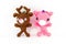 handmade crochet brown deer and pink pig doll on white background