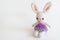 Handmade crochet doll. Cute rabbit doll on white background.