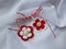Handmade crocheted flowers with red and white string, known as Martisor.