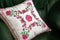 Handmade decorative pillow with rose embroidery.
