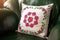 Handmade decorative pillow with rose embroidery.