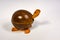 Handmade decorative smiling wooden turtle on a white background