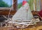 Handmade felt hen on wooden bench in front of old farmhouse window. Easter decoration.