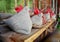 Handmade felt hens on wooden bench in front of old farmhouse window. Easter decoration. Selective focus.