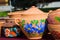 Handmade and handpainted ceramic clay jugs, pots with covers, bright floral patterns