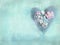 Handmade heart on grunge turquoise background.