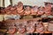 Handmade historical leather shoes for sale stacked on shelves at a medieval market, copy space, selected focus