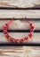 Handmade hoop Red flowers. Red berries hair band on wooden background. Top view