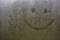 Handmade inscription on the sweaty glass smiley