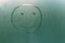 Handmade inscription on the sweaty glass smiley