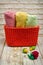 Handmade knitted basket and towels on white worn boards