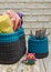 Handmade knitted basket and towels on white worn boards