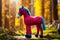 Handmade knitted or crocheted pink horse with blue mane and tail