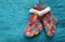 Handmade knitting socks with ornament hanging on ribbon. Christmas handmade decorations. Christmas colored boots in anticipation