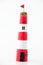 Handmade lighthouse from colored paper. Handicraft and hobby concept. Object on a white background