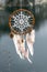 Handmade native american dream catcher on background of rocks an