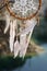 Handmade native american dream catcher on background of rocks an