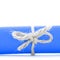 Handmade natural rope bow tied on blue message scroll isolated