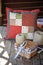 Handmade patchwork cushion with sewing tools on wooden table