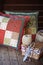 Handmade patchwork cushions with sewing tools on wooden table