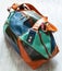 Handmade patchwork leather travel bag on gray