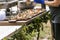 Handmade personal pizzas on a wooden cutting board made by a caterer at an outdoor summer party event