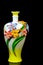 Handmade porcelain vase with decorative elements against dark background