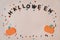Handmade Pumpkins, letters, rhinestones in a circle on a pink paper background. Halloween holiday concept top view. Space for text