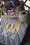 Handmade quilt blanket with cat on wooden table with twine and sewing tools