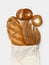 Handmade reusable cotton textile shopping bag with fresh bread, loaf and bagels on a white background. Zero waste, eco