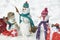 Handmade snowman in the snow outdoor. Greeting snowman. Winter snowman family. Mother snow-woman, father snow-man and