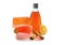 Handmade soap, orange colored shower gel bottle and cinnamon.