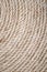 Handmade Table Mat of Jute Rope Twisted in a Spiral Form as Background