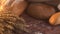 Handmade tasty bread lying on burlap on the wooden table with flour, wheat and ears of wheat