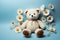 Handmade teddy bear adorned with daisies, set against a baby blue backdrop