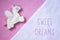 Handmade toy Pegasus on a pink felt background.  Handmade pink flat lay. Sewing funny felt pony with wings. Postcard.