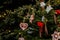 Handmade toys for Christmas tree decoration, an asterisk on green branches outdoor, toy made of wood, plaster and glitters,