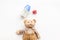 Handmade toys for newborn baby. Teddy bear. Feeding bottle with milk and dummy. White background top view