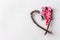 Handmade twigs heart half full of love illustrated by fluffy balls on white background for Valentine day