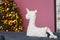 Handmade unicorn pillow on background of Christmas tree