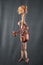 Handmade violoncello or violin like puppet on gray background